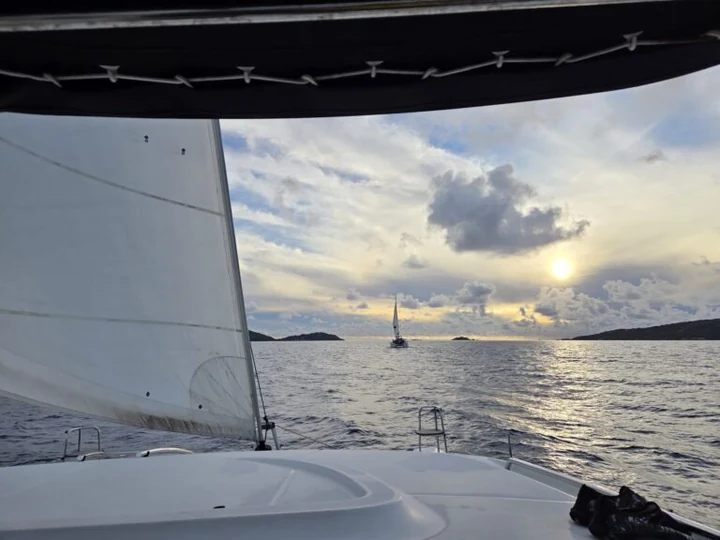 Mar, nuvens e outra embarcação vistos da proa.